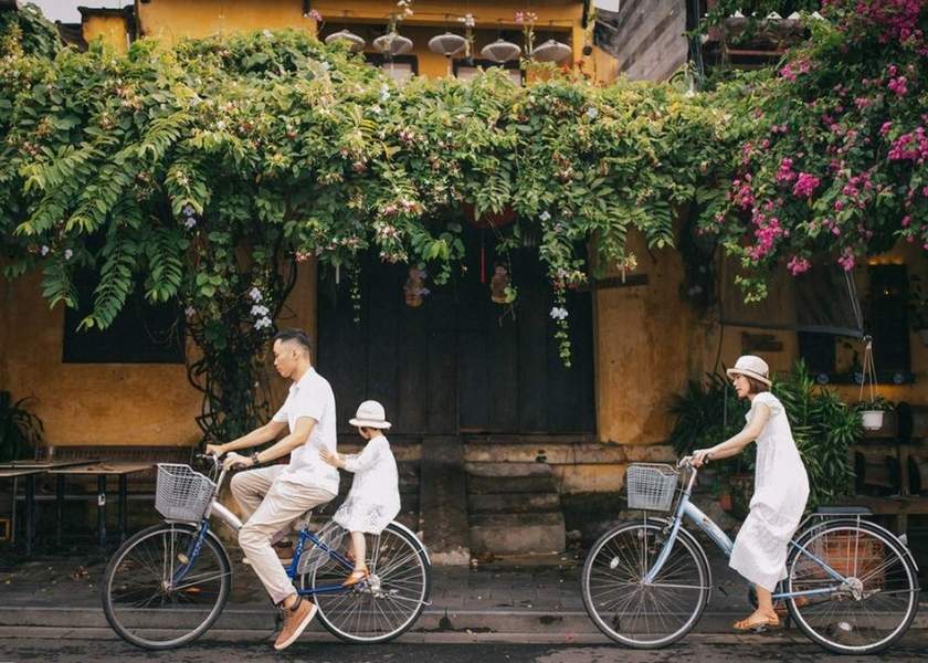 Riding a bicycle through the yellow streets of Hoi An Ancient Town and the organic vegetable fields of Tra Que.