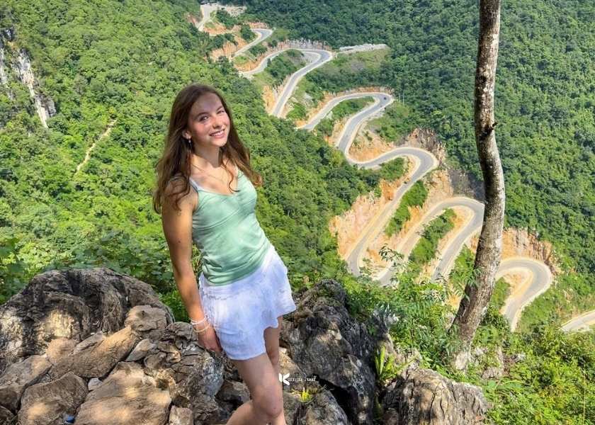 A candid photo of a female tourist at Khau Coc Cha Pass