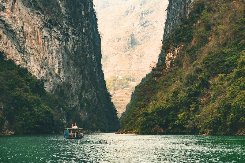 Boat cruising through the Nho Que River in Tu San Canyon, a scenic highlight of the Ha Giang Loop Vietnam