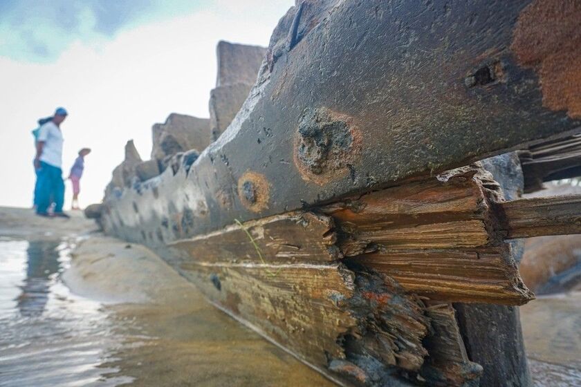 The hull of the ship was fully exposed from the sand as the tide went out