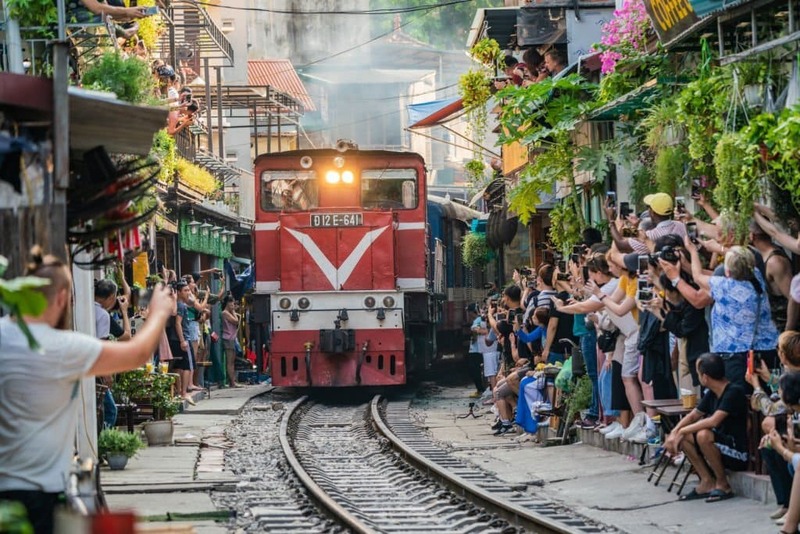 The trains cross very narrow streets.