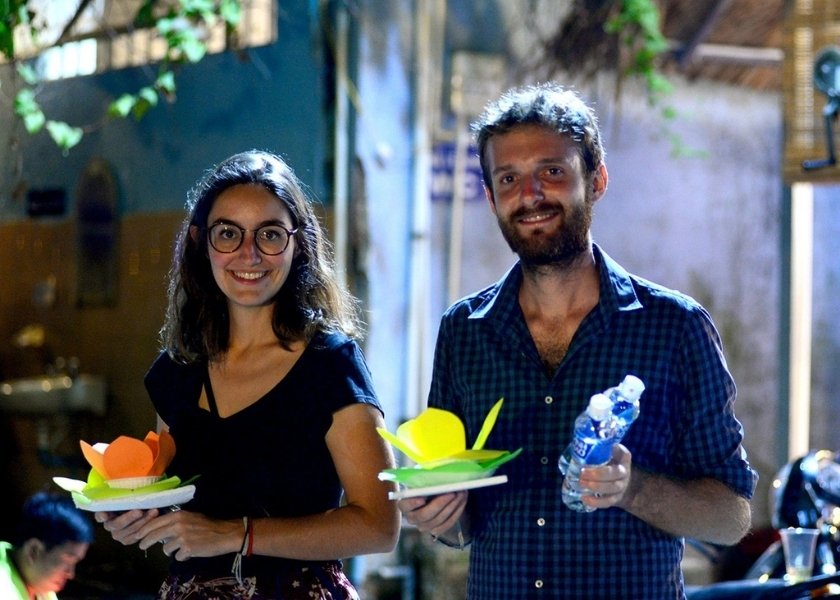Releasing floating lanterns in Hoi An