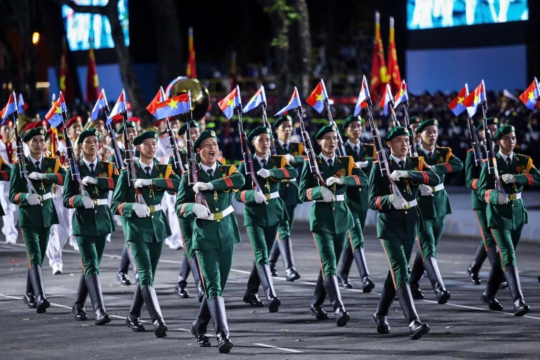 Locals applaud the military parade