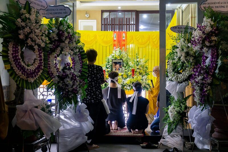Vietnamese funeral altar with flowers, incense and a memorial portrait